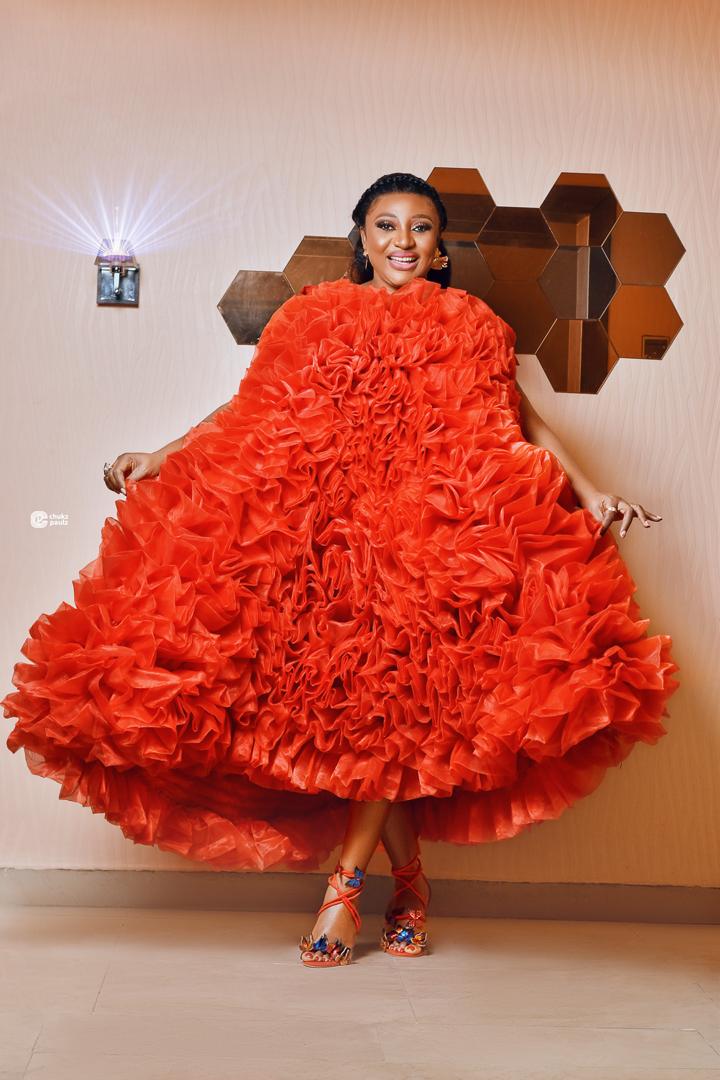 Voluminous coral gown covered in cascading sculptural ruffles