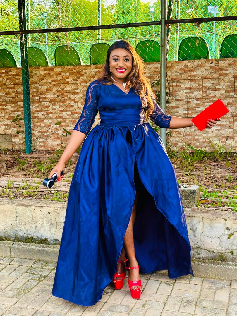Royal blue silk gown with lace sleeves and a high front slit