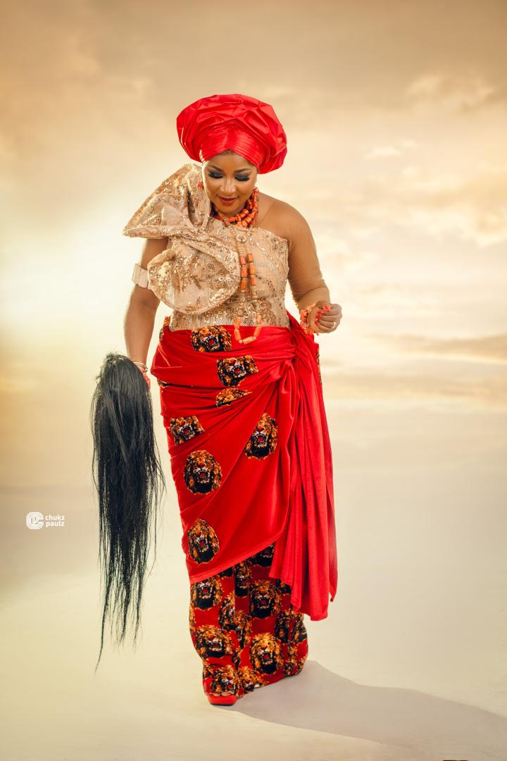 Red Isiagu traditional wrapper with gold beaded blouse, coral beads and red gele
