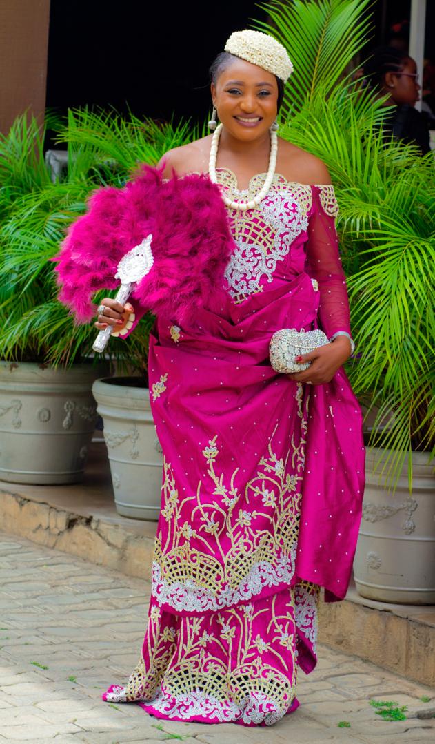 Fuchsia beaded traditional gown with silver embroidery, coral beads and feather fan